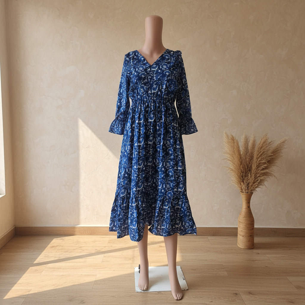 Indigo floral print cotton ruffle midi dress with balloon sleeves and flared hem, front view on mannequin
