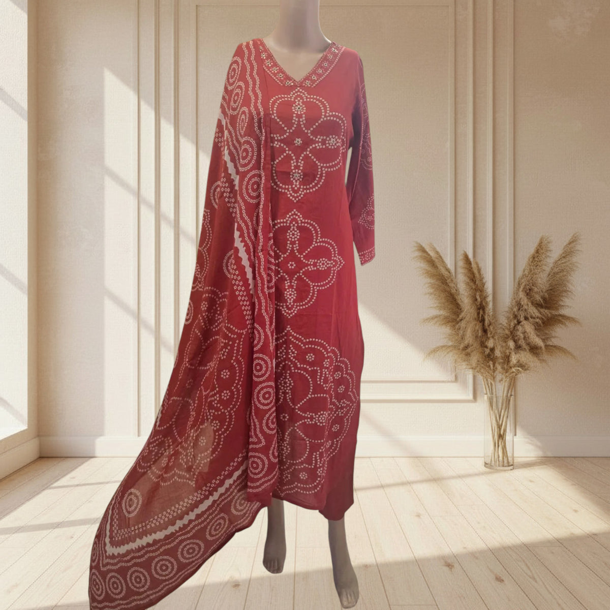 Rust cotton kurti with large Bandhej motifs and a detailed V-neckline border